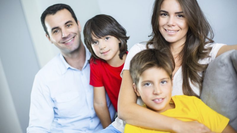 Happy family smiling at the camera.